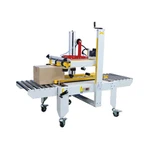 Machine à sceller les caisses à entraînement haut-bas